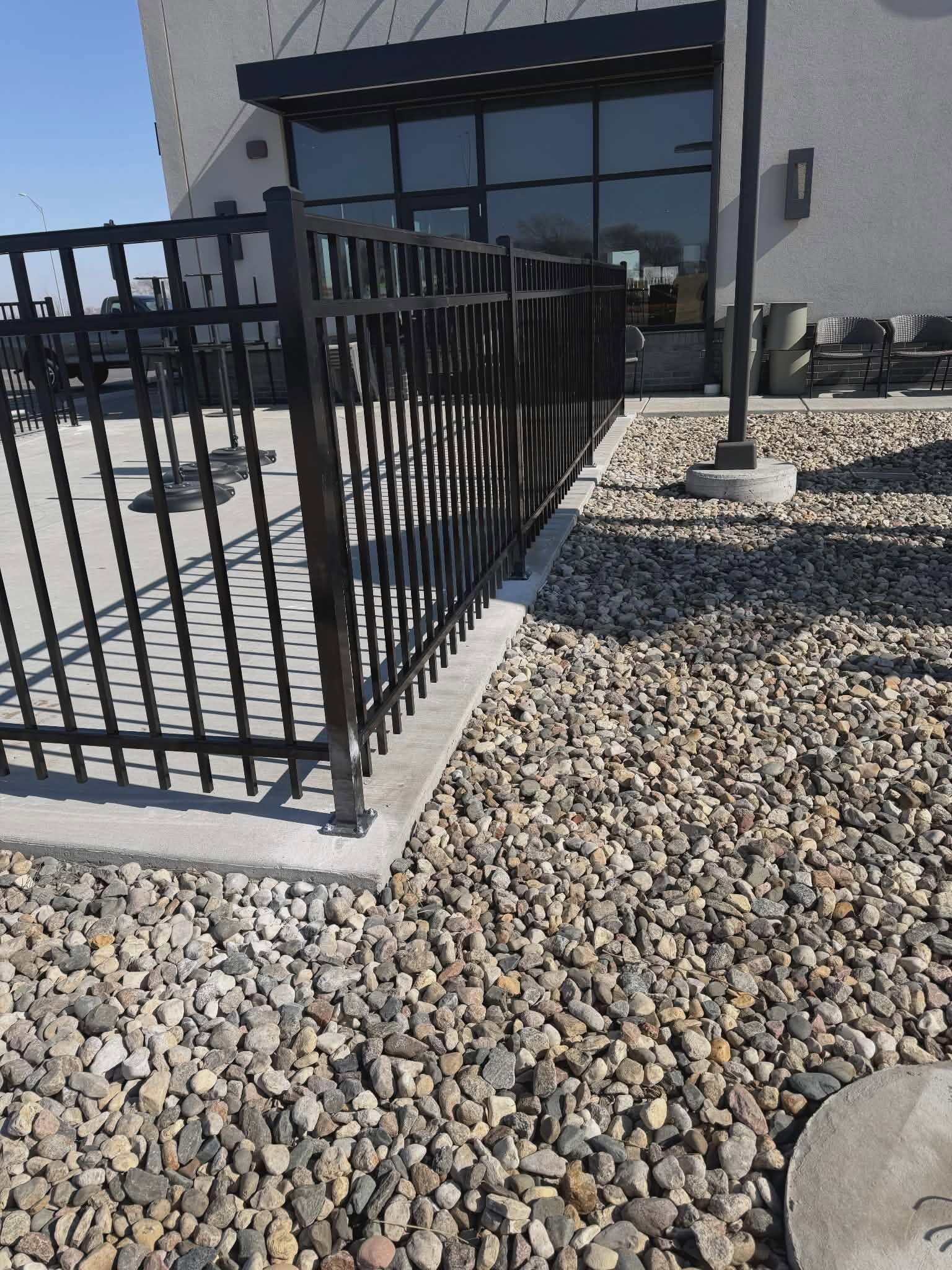 Black ornamental railing at a commercial building entrance