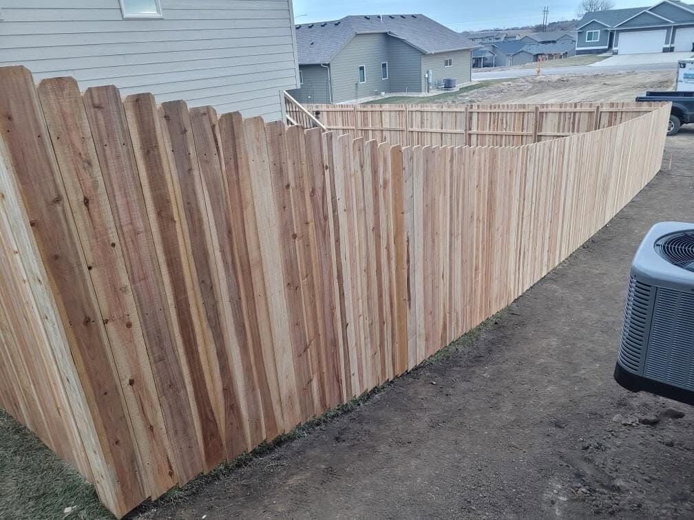 Cedar privacy fence beside an air conditioning unit