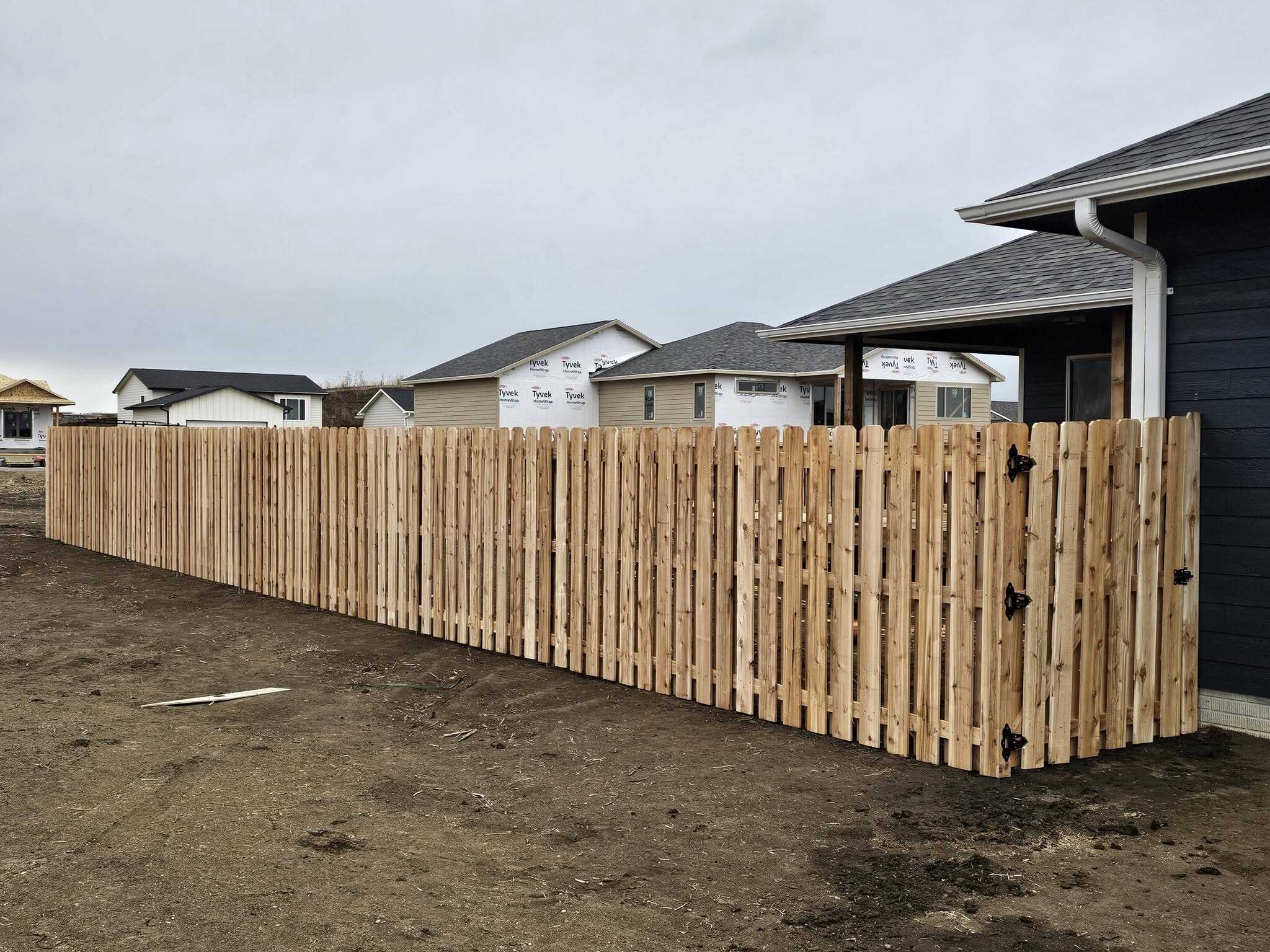 Cedar picket fence, long run in a new subdivision