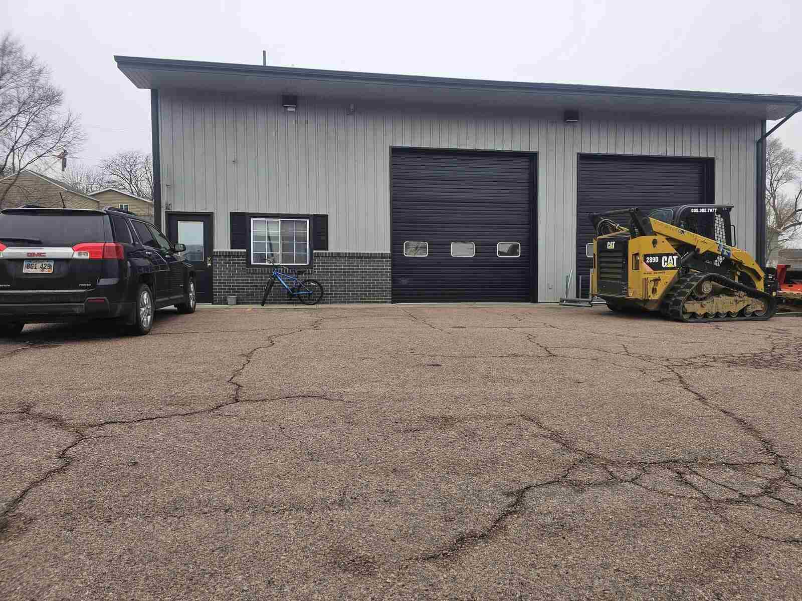The Nespor Fence shop in Mitchell with a truck and skid loader in the lot