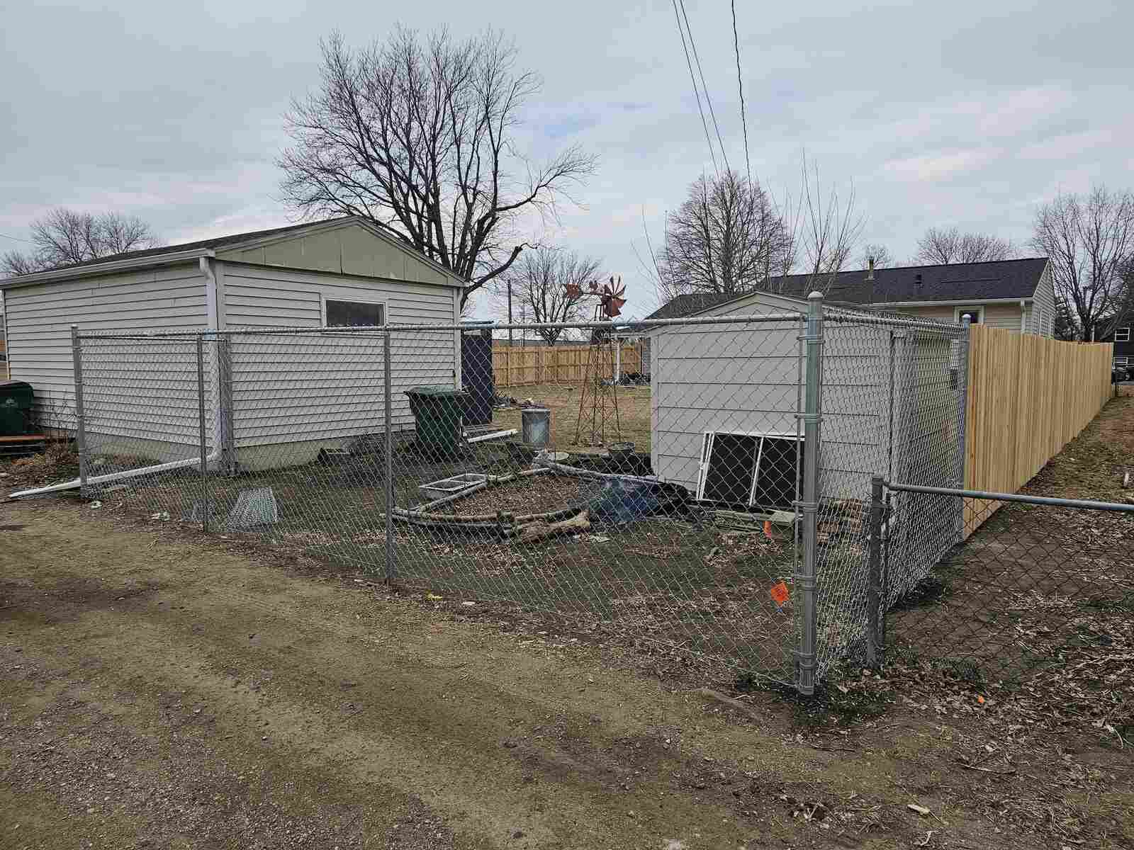 Galvanized chain link around a backyard shed and garden