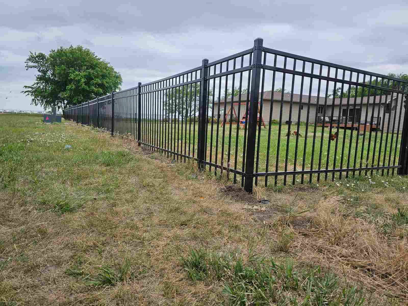Black ornamental iron fence, long rural run