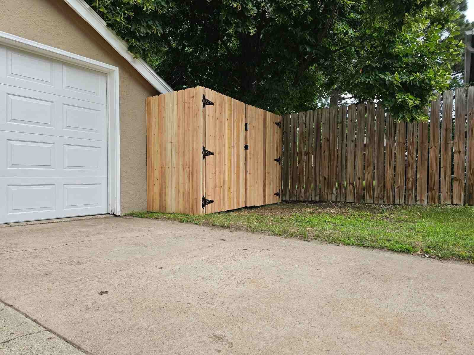 Cedar privacy fence with a double gate at the garage