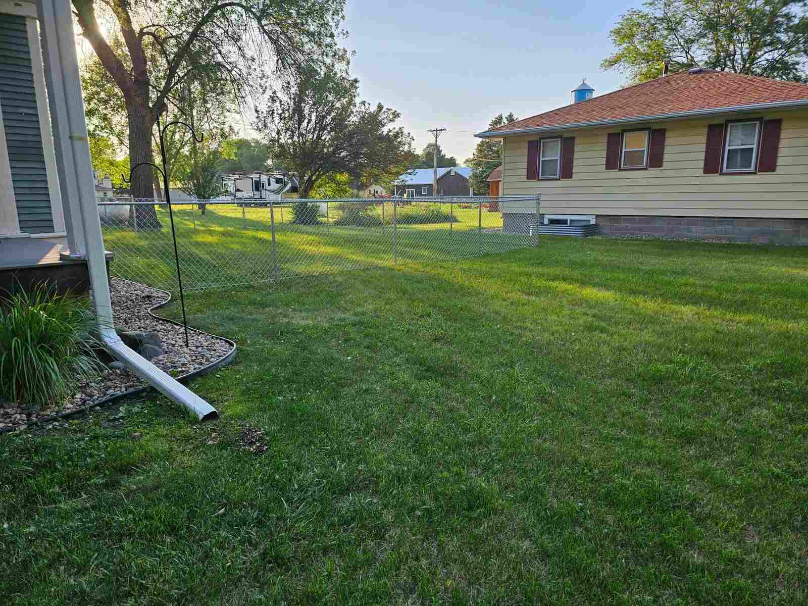 Galvanized chain link crossing an open backyard