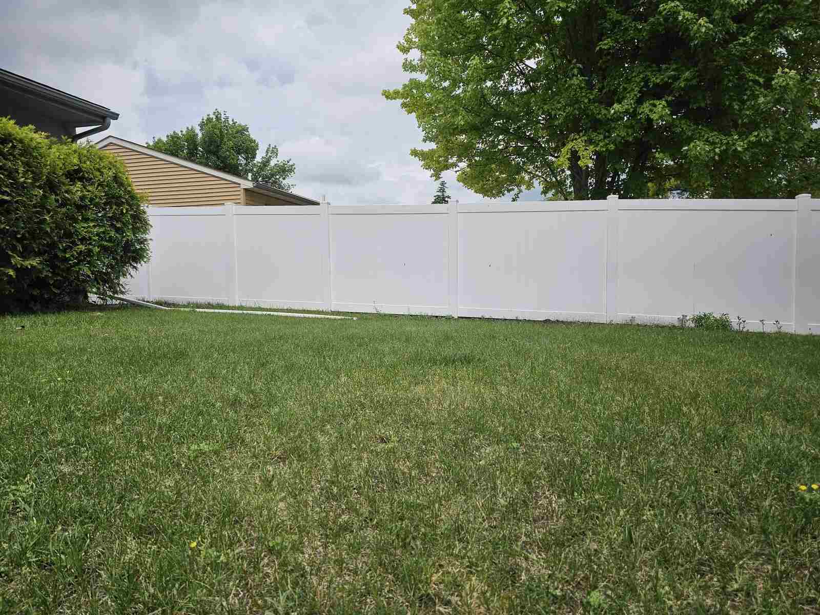 White vinyl privacy fence, long backyard run