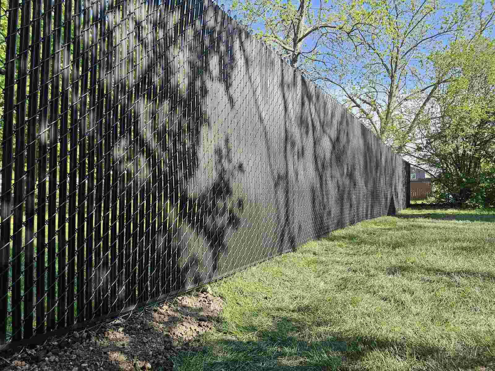 Black chain link fence with black privacy slats woven in
