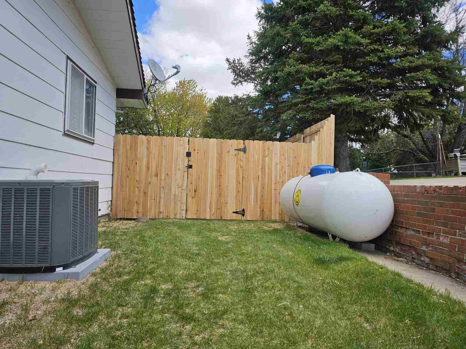Cedar privacy fence corner around utilities