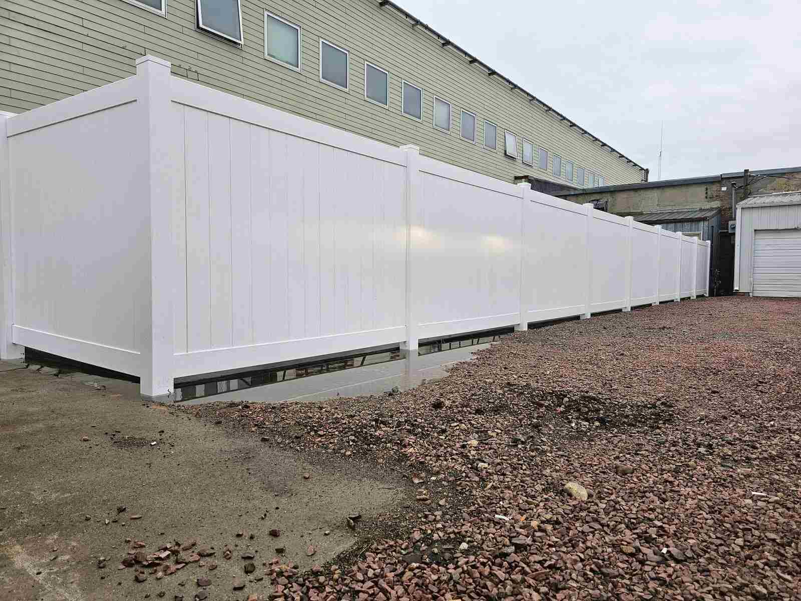 White vinyl privacy screen at a commercial building